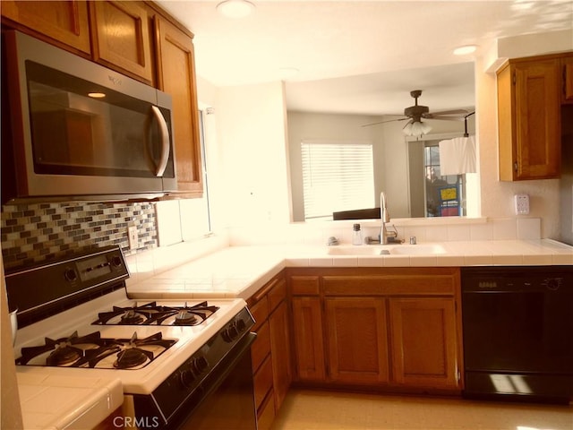 1806 Rory Ln Unit 9, Simi Valley, CA 93063 - kitchen with white range with gas stovetop, dishwasher, stainless steel microwave, and tile countertops