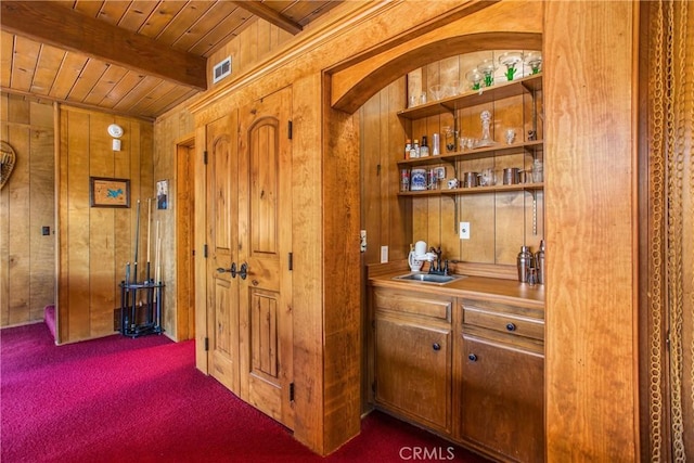28834 Zion Dr, Lake Arrowhead, CA 92352 - hallway featuring wooden walls, wood ceiling, beamed ceiling, a sink, and carpet flooring