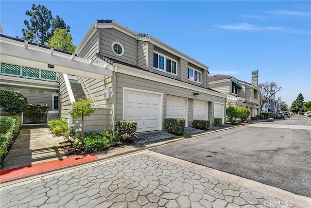 7402 Yellowtail Dr Unit 204, Huntington Beach, CA 92648 - view of side of home featuring an attached garage and a residential view