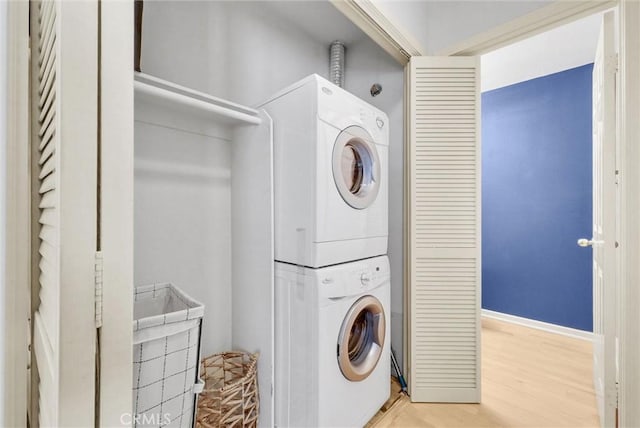 7402 Yellowtail Dr Unit 204, Huntington Beach, CA 92648 - washroom with stacked washer / drying machine and light wood-style flooring