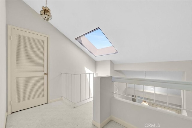 7402 Yellowtail Dr Unit 204, Huntington Beach, CA 92648 - hallway featuring vaulted ceiling, a skylight, carpet floors, and an upstairs landing