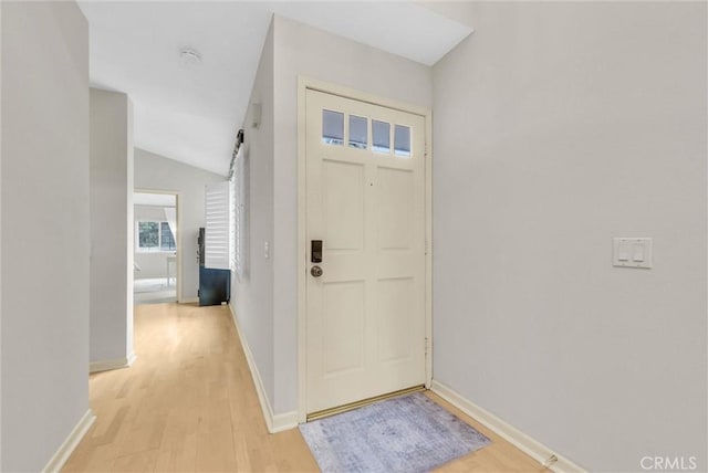 7402 Yellowtail Dr Unit 204, Huntington Beach, CA 92648 - foyer entrance with light wood finished floors and lofted ceiling