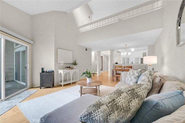 7402 Yellowtail Dr Unit 204, Huntington Beach, CA 92648 - living area featuring a chandelier, wood finished floors, and a high ceiling
