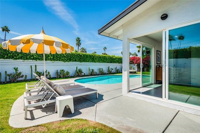 view of pool featuring a patio and a fenced backyard