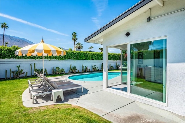 view of swimming pool featuring a patio and a mountain view
