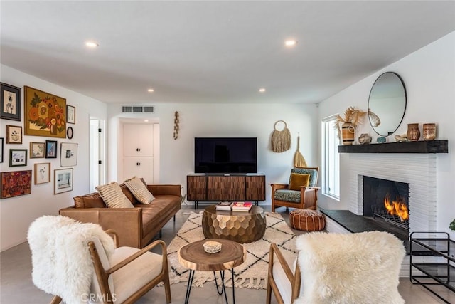 living room with a fireplace and recessed lighting