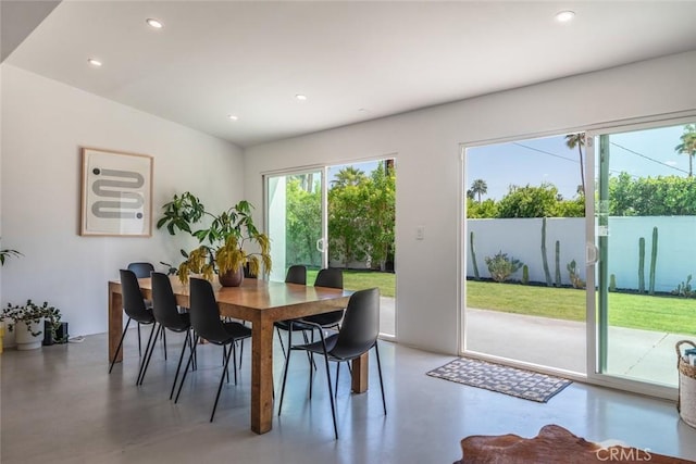 dining area featuring finished concrete flooring and recessed lighting