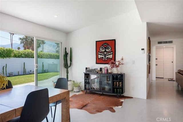 dining room with finished concrete flooring and recessed lighting