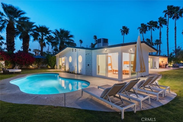 swimming pool featuring a patio and a lawn