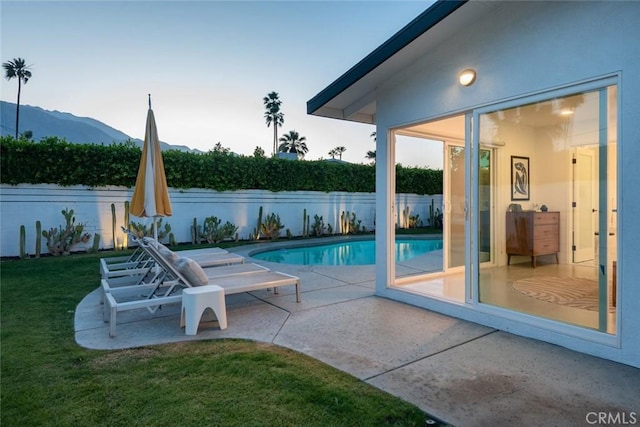 view of pool with a mountain view and a patio area
