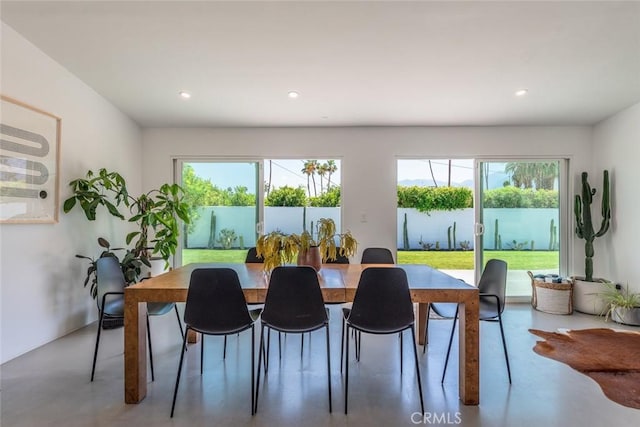 dining area with finished concrete flooring and recessed lighting