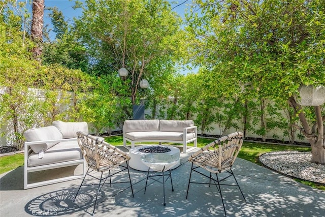 view of patio / terrace featuring an outdoor living space with a fire pit and a fenced backyard