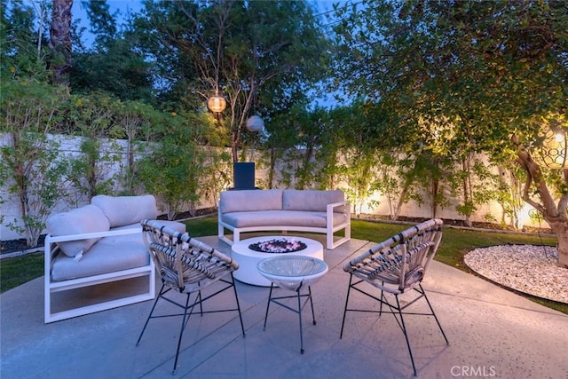 view of patio / terrace with an outdoor living space with a fire pit and a fenced backyard