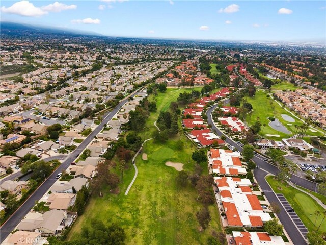aerial overview of property's location with nearby suburban area and a golf course