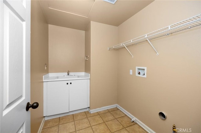 laundry area with cabinet space, light tile patterned flooring, washer hookup, and baseboards