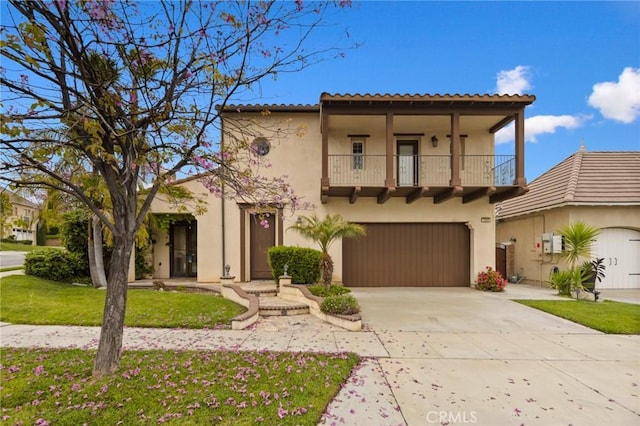 mediterranean / spanish house featuring a balcony, stucco siding, driveway, a garage, and a tiled roof