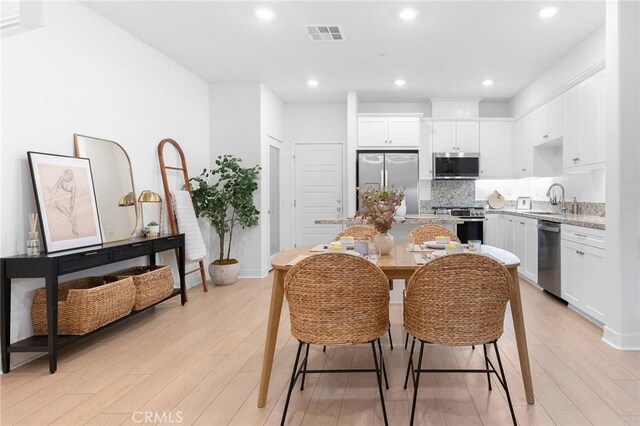 2616 Winston Ct, Arcadia, CA 91007 - kitchen with stainless steel appliances, a sink, light wood-style flooring, white cabinets, and recessed lighting