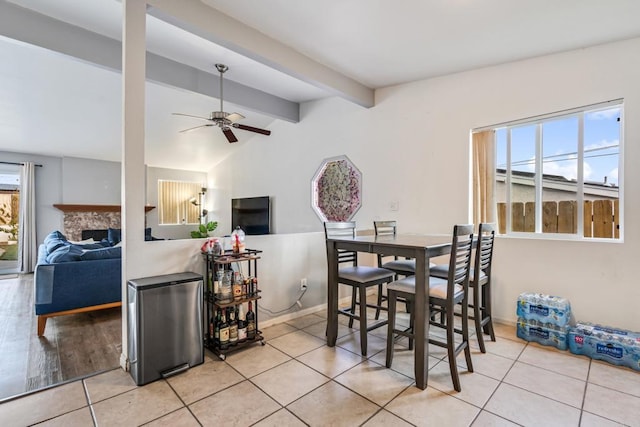 2045 Cardinal Dr, San Diego, CA 92123 - tiled dining space featuring ceiling fan, a fireplace, and baseboards