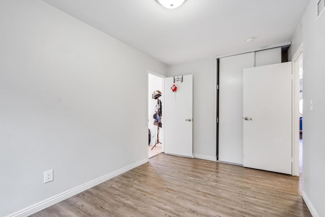 2045 Cardinal Dr, San Diego, CA 92123 - unfurnished bedroom featuring wood finished floors, baseboards, and a closet