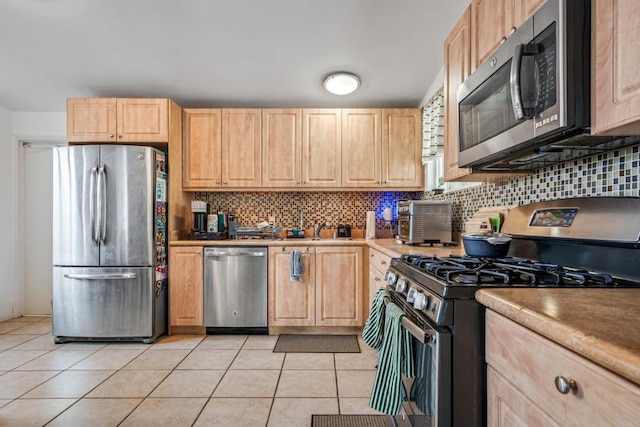 2045 Cardinal Dr, San Diego, CA 92123 - kitchen featuring stainless steel appliances, light brown cabinets, light tile patterned floors, backsplash, and a sink