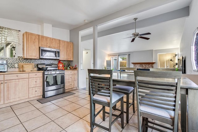 2045 Cardinal Dr, San Diego, CA 92123 - kitchen with appliances with stainless steel finishes, light brown cabinets, ceiling fan, tasteful backsplash, and light tile patterned floors