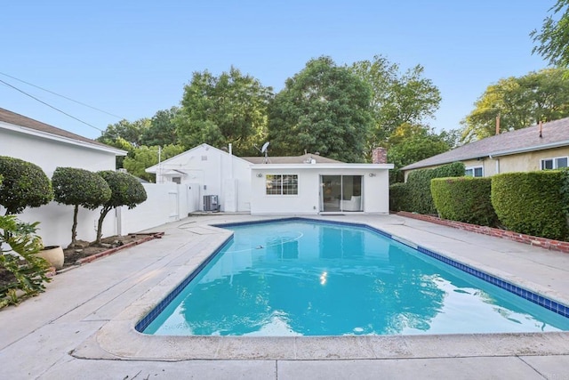 view of pool featuring a fenced backyard, a patio area, and central AC unit