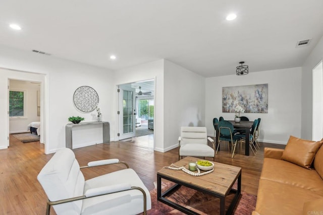 living room with wood finished floors, recessed lighting, baseboards, and a ceiling fan
