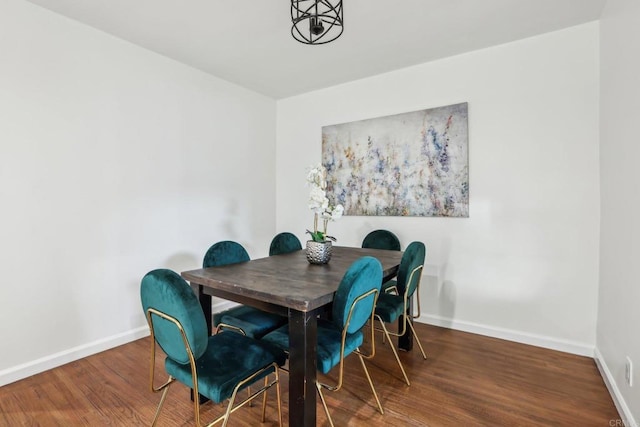 dining area featuring baseboards and wood finished floors