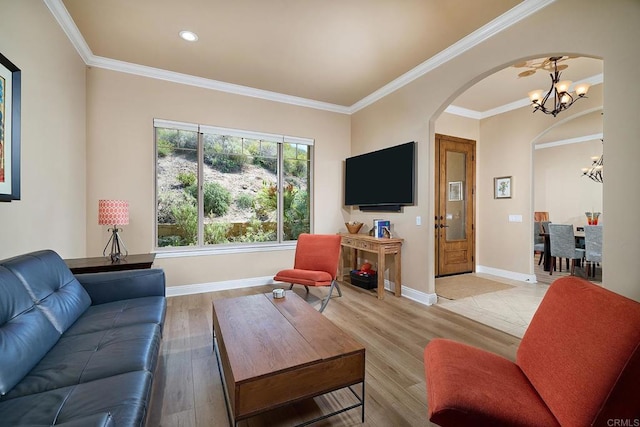 2021 Willow Glen Rd, Fallbrook, CA 92028 - living room featuring a chandelier, arched walkways, baseboards, light wood-style floors, and crown molding
