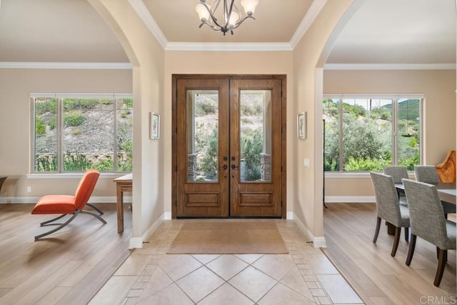 2021 Willow Glen Rd, Fallbrook, CA 92028 - entryway with arched walkways, plenty of natural light, a chandelier, and ornamental molding