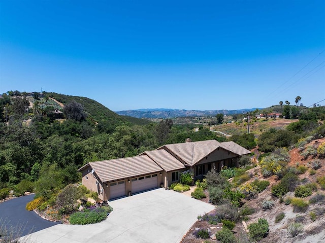 2021 Willow Glen Rd, Fallbrook, CA 92028 - view of front of property with a garage, a tile roof, concrete driveway, a chimney, and stucco siding