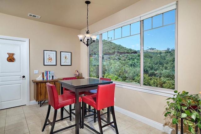 2021 Willow Glen Rd, Fallbrook, CA 92028 - dining room featuring baseboards, a chandelier, light tile patterned floors, and healthy amount of natural light