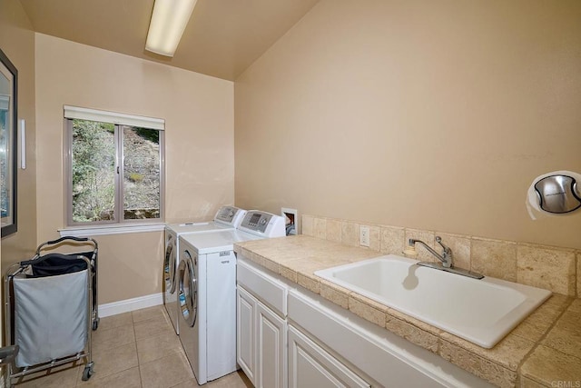 2021 Willow Glen Rd, Fallbrook, CA 92028 - washroom with washing machine and dryer, cabinet space, light tile patterned floors, and baseboards