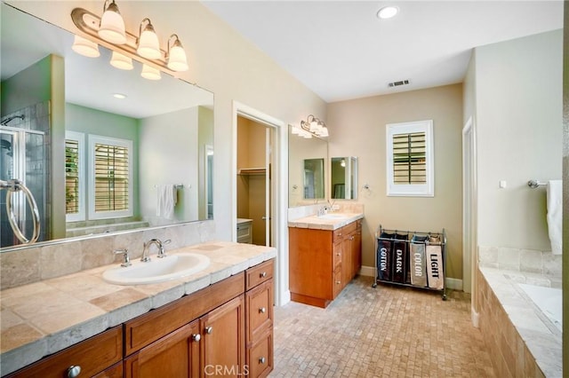 7 Honeydew, Irvine, CA 92603 - full bathroom with a stall shower, two vanities, tiled bath, and recessed lighting