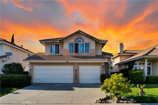 14028 Yorktown Ct, Fontana, CA 92336 - view of front of property with a tiled roof, a garage, stucco siding, and driveway