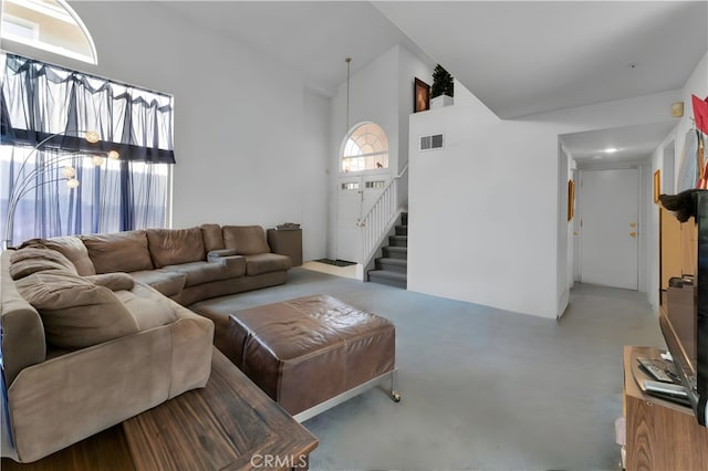 14028 Yorktown Ct, Fontana, CA 92336 - living area featuring stairway, concrete floors, and high vaulted ceiling