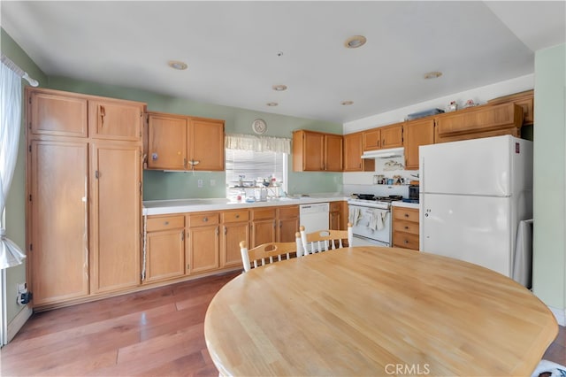 14028 Yorktown Ct, Fontana, CA 92336 - kitchen with white appliances, under cabinet range hood, light countertops, light wood finished floors, and recessed lighting