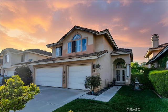 14028 Yorktown Ct, Fontana, CA 92336 - view of front of property featuring a tile roof, a garage, french doors, and stucco siding