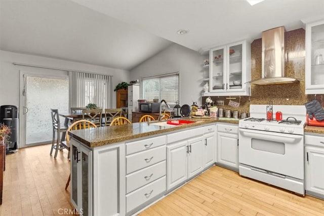 2522 S Calaveras Pl, Ontario, CA 91761 - kitchen with white range with gas cooktop, wall chimney exhaust hood, a peninsula, black microwave, and a sink
