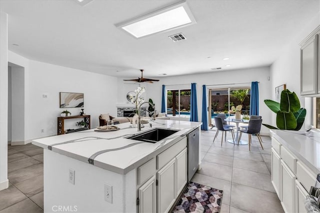 3773 Mission, Peak, Palm Springs, CA 92262 - kitchen featuring a sink, stainless steel dishwasher, open floor plan, light stone countertops, and a kitchen island with sink