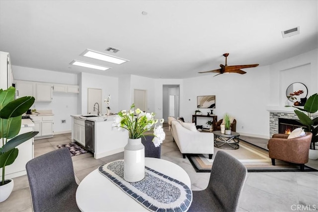 3773 Mission, Peak, Palm Springs, CA 92262 - dining space featuring a stone fireplace, a ceiling fan, and light tile patterned floors