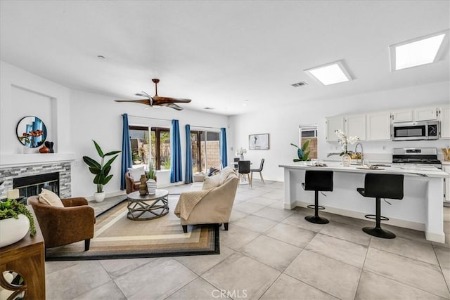 3773 Mission, Peak, Palm Springs, CA 92262 - living room with a fireplace, light tile patterned floors, and baseboards