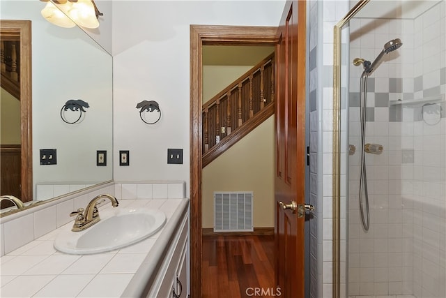 27513 St Bernard Ln, Lake Arrowhead, CA 92352 - bathroom with a shower stall, wood finished floors, vanity, and baseboards