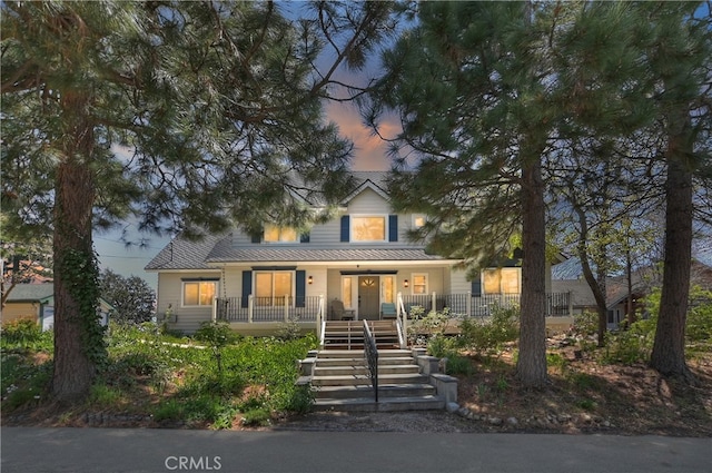 27513 St Bernard Ln, Lake Arrowhead, CA 92352 - view of front of house with covered porch, stairs, and metal roof