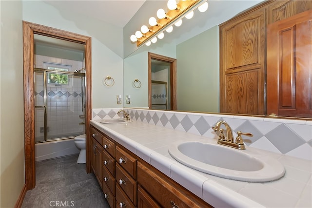 27513 St Bernard Ln, Lake Arrowhead, CA 92352 - bathroom featuring toilet, double vanity, shower / bath combination with glass door, and tasteful backsplash