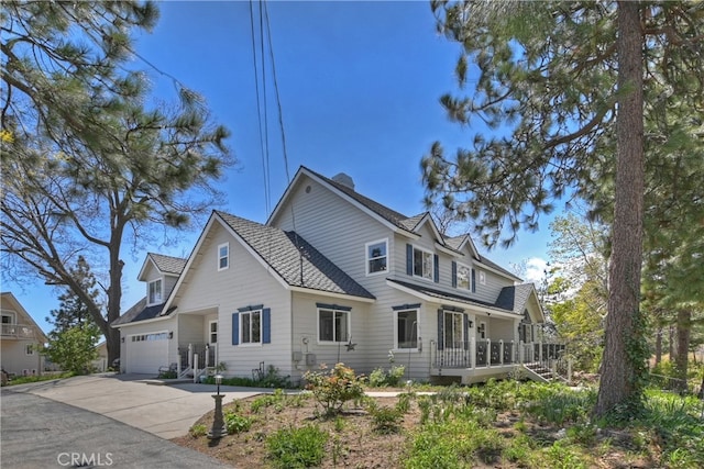 27513 St Bernard Ln, Lake Arrowhead, CA 92352 - view of front of house with driveway, a garage, a wooden deck, and a shingled roof