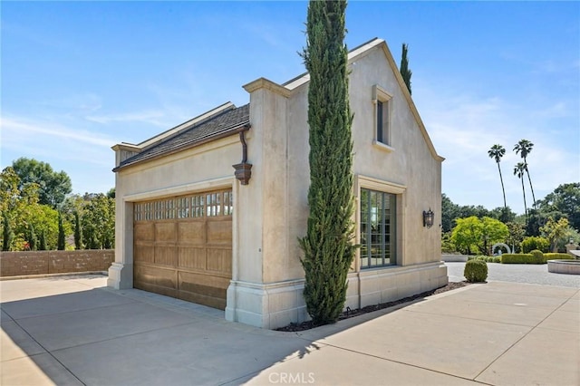 18 Dovetail Ln, Bradbury, CA 91008 - view of side of property with concrete driveway, a garage, and stucco siding