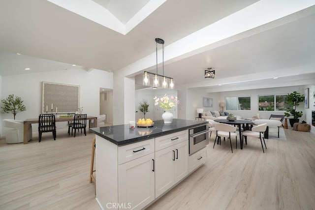 2610 King Way, Claremont, CA 91711 - kitchen with open floor plan, light wood-style floors, white cabinets, dark countertops, and a center island