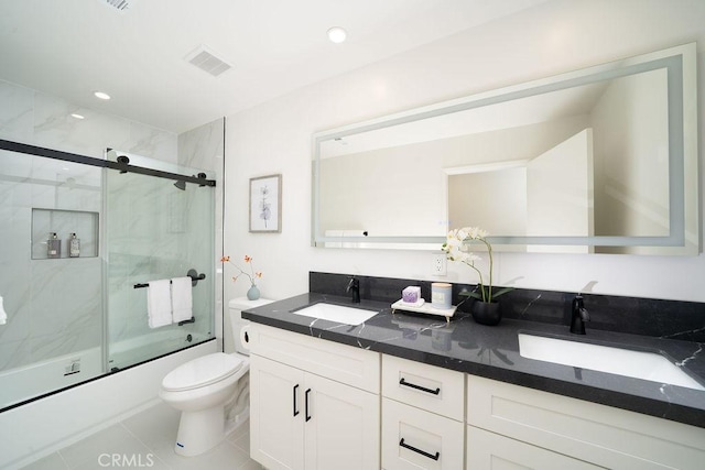 2610 King Way, Claremont, CA 91711 - bathroom featuring toilet, double vanity, combined bath / shower with glass door, and tile patterned floors