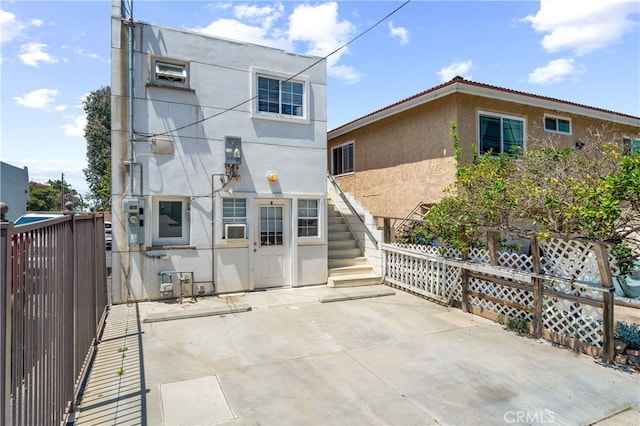 2707 S El Camino Real, San Clemente, CA 92672 - rear view of house with stucco siding, stairway, fence, and a patio area